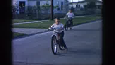 New Orleans Louisiana USA (1958): Two Young Children Riding Their Bikes Down The