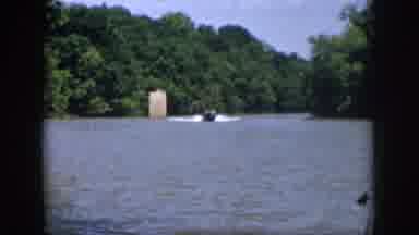 Virginia USA (1958): A Man Waves His Hand While Riding In A Motorboat At A Lake