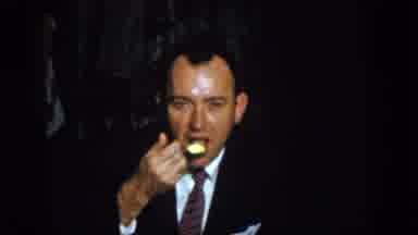 Virginia USA (1958): A Man Laughing With A Friend While He Eats With A Spoon