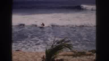 Hawaii USA (1959): A Man Is Surfing With Skimboard In The Beach