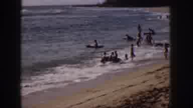 Hawaii USA (1959): Beach Goers Enjoy Frolicking Amongst The Waves