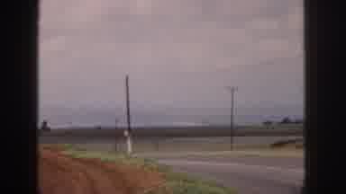 Hawaii USA (1959): Woman In Pink Dress With Boy In Yellow Shirt On Side Of The