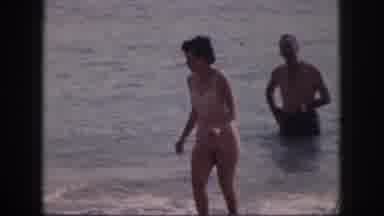 Hawaii USA (1959): Man And Woman Walking In The Ocean Toward Beach