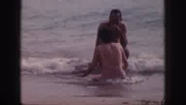 Hawaii USA (1959): Couple Sits On Beach Man Walking On Boardwalk