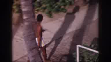 Hawaii USA (1959): Thirsty Ethnic Beach Goer Seen Taking A Drink At Water Fountain