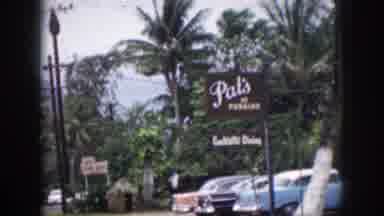 Hawaii USA (1959): Colorful Cars Drive Tropical Mountainside Road Near Wooded Lot