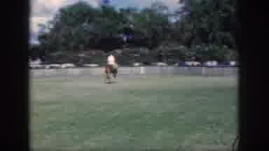 Oahu Hawaii USA (1959): A Man Rides A Tall Horse Across Some Lush Green Grass