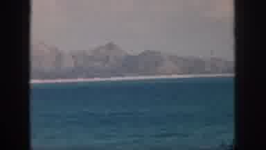 Oahu Hawaii USA (1959): A Group Of Mountains Sitting On The Beach In Front Of