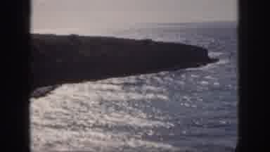 Oahu Hawaii USA (1959): A Person Standing In The Ocean Waves At The Rocky Shore