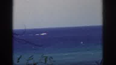 Oahu Hawaii USA (1959): A Boat Speeding Down The Waterway, And A Small House On