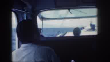 Oahu Hawaii USA (1959): Men In The Cabin Of A Power Boat On The Sea Or A Large