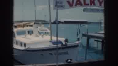 Oahu Hawaii USA (1959): Large Boat Pulling Into The Harbor With Woman Wearing Lays