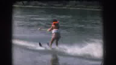 Grand Rapids Michigan USA-1961: Water Skier Glides Across Lake With Orange Life Vest