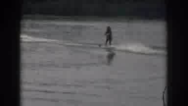 Grand Rapids Michigan USA-1961: Person Water Skiing Behind A Boat On A Smooth Lake