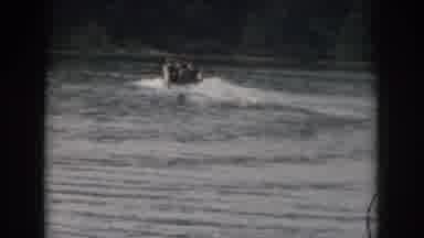 Grand Rapids Michigan USA (1961): Water Skier Following A Boat With Lush Greenery