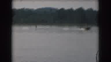 Grand Rapids Michigan USA (1961): Jet Skier Chasing The Motorboat Around The Tree