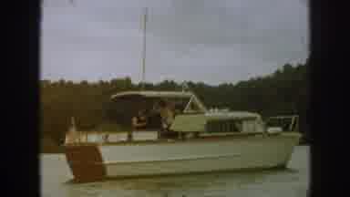 Michigan USA (1961): People On White Boat With Flag Moving Slowly Through The