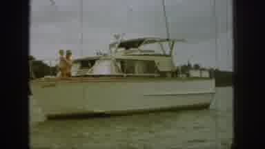 MICHIGAN USA-1961: Dad And Child On The Bow Of The Cabin Cruiser, Motoring Along