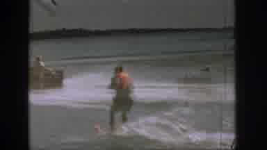 Michigan USA (1961): People Riding On A Boat And Pulling Along A Jet Ski