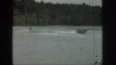 Michigan USA (1961): Man Playing In Water And Jumping Into A Boat