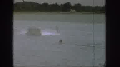 Michigan USA (1961): A Group Of People Sit In A Motor Boat In A Lake And Watch A