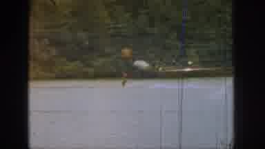 MICHIGAN USA-1961: From The Window Of A Ship, Someone Films A Person Who Is Water Skiing