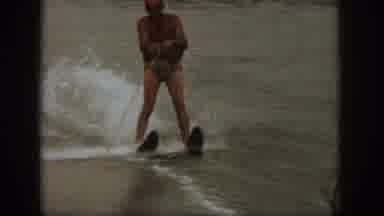 Michigan USA (1961): Home Video Taking From Boat Of Two Skiers Skiing Next To One