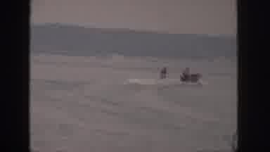 Michigan USA (1961): Man Rapidly Waterskiing With Skill And Balance Toward Small