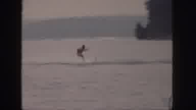 Michigan USA (1961): Beautiful Male Water Skier Is Pulled By Motor Boat In Upper