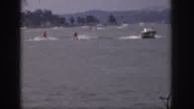 Michigan USA (1961): Two People Water Skiing Behind A Boat In A Crowded Water Area