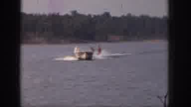 Michigan USA (1961): Vintage Video Waterskiing On Lake With Boat With Trees In