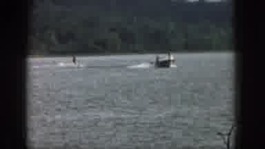 Michigan USA (1961): Surfer Tied To A Boat Driven By Two People, The Water Looks