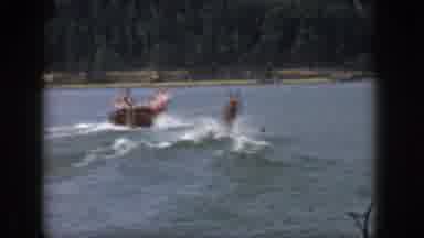 Michigan USA (1961): People In Boat Pulling Water Skier In Large Body Of Water