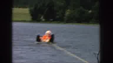 Michigan USA (1961): Person Learning How To Ski At The Lake On A Sunny Day