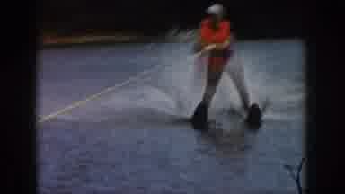 Michigan USA (1961): Woman Water Skis On Lake Wearing Life-Preserver
