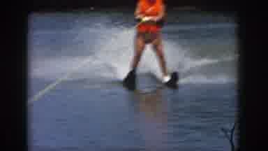 Michigan USA (1961): A Boat Floating On Water, Followed By A Person Jet-Skiing
