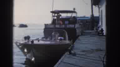 Michigan USA (1961): Two Boats Slowly Rock As They Are Anchored To A Dock