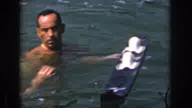 Michigan USA (1961): Man With White Swimsuit Putting On, Getting Up On Water Skis