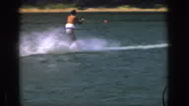 Michigan USA (1961): A Man Making A Large Splash Of Waves As He Jet-Skis Through A