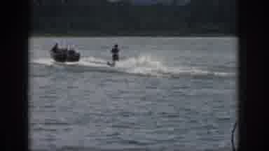 Michigan USA (1961): Group Of Vacationers Water-Ski In A Lake On A Bright Day
