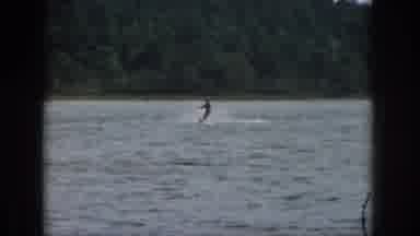 Michigan USA (1961): Man Enjoys Water Skiing At Night On A Calm Lake With Faint