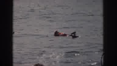Michigan USA (1961): Two Men In Life Vests In The Water One Swimming Towards The