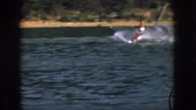 Michigan USA (1961): Shirtless Man Water Skiing On A Sunny Day At At The Lake