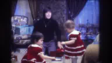 Medford New Jersey USA (1973): Two Small Girls Are Opening Christmas Gifts,