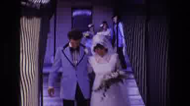 Boston USA (1974): Man In Blue Suit And Bride In White Dress Walking Down Hallway