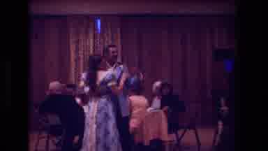 Boston USA (1974): Woman In Blue Dress Dances At Celebration With Man In Blue Suit