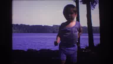 Baxter Maine USA (1975): Little Tough Guy Walks Up To Camera With Trees And Lake