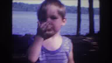 Baxter Maine USA (1975): A Child Near The Beach He Smells His Fingers Then Points