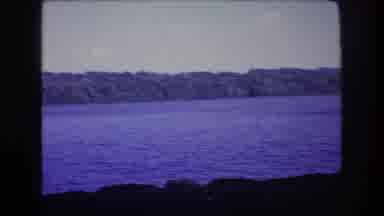 Baxter Maine USA (1975): Trees In The Background Rocks Near The Water