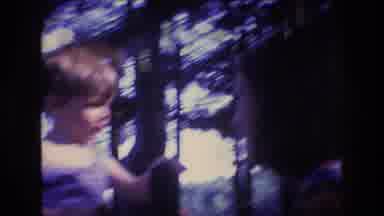 Baxter Maine USA (1975): Person Recording A Small Boy Playing With A Person
